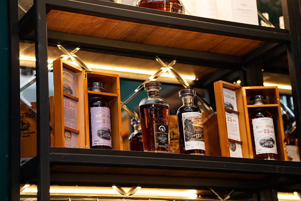 Edradour 25 Year Old bottlings in wooden boxes on the shelf at BARD Whisky Bar